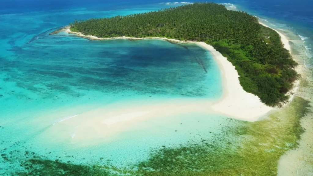 Aerial view of the Amindivi Islands, part of the Lakshadweep archipelago in the Arabian Sea, showcasing its coral atolls and lush green landscape.